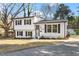 Inviting two-story house with a fresh white exterior, dark shutters, and a neatly paved driveway at 1004 Helms Pl, Raleigh, NC 27610