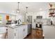 Bright modern kitchen featuring stainless steel appliances, granite countertops, and wood flooring at 1004 Helms Pl, Raleigh, NC 27610