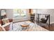 Spacious living area includes stylish decor, comfortable seating, and large windows with natural light at 1004 Helms Pl, Raleigh, NC 27610