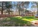 Spacious backyard with lush green grass and a wooden privacy fence at 101 Weatherly Pl, Cary, NC 27518
