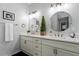 Bathroom with double vanity, white countertop, and round mirrors with bronze hardware at 101 Weatherly Pl, Cary, NC 27518