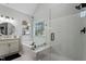 Bright bathroom featuring a glass shower, soaking tub, and decorative shelving at 101 Weatherly Pl, Cary, NC 27518