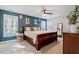 Spacious bedroom with large windows, a ceiling fan, and stylish decor at 101 Weatherly Pl, Cary, NC 27518