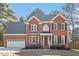 Traditional two-story brick home featuring a manicured lawn and attached two car garage at 101 Weatherly Pl, Cary, NC 27518