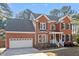 Charming two-story brick home with a well-manicured front yard and attached garage at 101 Weatherly Pl, Cary, NC 27518
