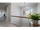 Well-lit hallway with a large arched window and white banister at 101 Weatherly Pl, Cary, NC 27518