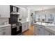 Stylish kitchen features stainless steel appliances, white cabinets, and breakfast nook at 101 Weatherly Pl, Cary, NC 27518