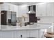 Modern kitchen showcasing white cabinetry, stainless steel appliances, and a stylish black and white backsplash at 101 Weatherly Pl, Cary, NC 27518