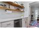 Kitchen features white cabinets, quartz countertops, open shelving, and stainless appliances at 101 Weatherly Pl, Cary, NC 27518