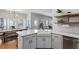 Well-lit kitchen featuring white cabinets, stainless steel appliances, and hardwood floors at 101 Weatherly Pl, Cary, NC 27518