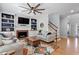 Inviting living room featuring a fireplace, built-in shelving, and hardwood floors at 101 Weatherly Pl, Cary, NC 27518