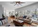 Spacious living room and dining area with hardwood floors, neutral decor, and a ceiling fan at 101 Weatherly Pl, Cary, NC 27518