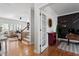 Home office featuring wood floors, french doors, built-in shelving, and views to the living area at 101 Weatherly Pl, Cary, NC 27518