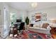 Bright room featuring a home office and seating area with hardwood floors and modern decor at 101 Weatherly Pl, Cary, NC 27518