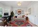 Bright room featuring a home office and living area with hardwood floors and modern decor at 101 Weatherly Pl, Cary, NC 27518