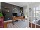 Bright home office features a modern desk, black accent wall, and a comfortable seating area at 101 Weatherly Pl, Cary, NC 27518