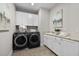 Laundry room with modern washer and dryer, cabinets, a sink, and decorative countertop at 1013 Manchaca Loop, Apex, NC 27539