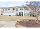 Backyard view of the townhouse featuring a privacy fence, back patio, and dormant grass lawn at 1019 Navigon Dr, Durham, NC 27713