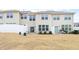 View of the townhouse's backyard featuring a privacy fence, back patio, and dry grass lawn at 1019 Navigon Dr, Durham, NC 27713