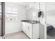 Bright bathroom featuring double vanity, large mirror, and tiled floor at 1019 Navigon Dr, Durham, NC 27713