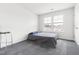 Minimalist bedroom with gray carpet, a small bed, and a bright window at 1019 Navigon Dr, Durham, NC 27713