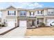 Charming townhome featuring a stone facade, attached garage, well-maintained landscaping, and inviting curb appeal at 1019 Navigon Dr, Durham, NC 27713