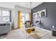 Comfortable living space with an artistic gray accent wall, modern lighting, and a cozy seating arrangement at 1019 Navigon Dr, Durham, NC 27713