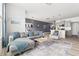 Open-concept living room featuring a comfortable sofa, modern decor, and a well-lit kitchen area at 1019 Navigon Dr, Durham, NC 27713