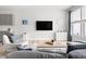 Bright living room features modern furnishings, a large flat-screen TV, and lots of light at 1019 Navigon Dr, Durham, NC 27713