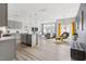 Bright, open-concept living room with sleek finishes and a modern kitchen featuring stainless steel appliances at 1019 Navigon Dr, Durham, NC 27713