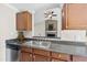 Kitchen featuring stainless steel sink, dishwasher, and a view into the adjacent living room at 103 Willoughby Ln, Cary, NC 27513