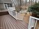 Multi-level deck with stairs leading down to a playground area with a tire swing at 104 Manchester Pl, Chapel Hill, NC 27516