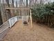 Backyard playground area featuring a tire swing and surrounding woods at 104 Manchester Pl, Chapel Hill, NC 27516