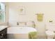Bathroom showcasing modern freestanding tub, stylish tiles, marble countertops and window at 104 Manchester Pl, Chapel Hill, NC 27516