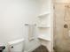 Modern bathroom featuring a tiled shower, built-in shelves, and updated fixtures at 104 Manchester Pl, Chapel Hill, NC 27516