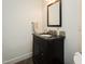 Powder room featuring dark vanity with granite countertop and decorative tile backsplash at 104 Manchester Pl, Chapel Hill, NC 27516