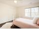 Cozy bedroom featuring hardwood floors, a ceiling fan, and a comfortable bed with plush pillows at 104 Manchester Pl, Chapel Hill, NC 27516