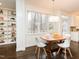 Bright dining space featuring hardwood floors, a modern chandelier, and custom shelving at 104 Manchester Pl, Chapel Hill, NC 27516
