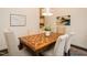 Elegant dining room featuring a patterned wood table, seating for six, and stylish decor with decorative lighting at 104 Manchester Pl, Chapel Hill, NC 27516