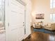 Bright foyer showcasing hardwood floors, two-story ceilings, and a glimpse into the adjacent living space at 104 Manchester Pl, Chapel Hill, NC 27516