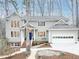 Charming two-story home featuring a well-manicured front yard, attached garage, and a classic blue front door at 104 Manchester Pl, Chapel Hill, NC 27516