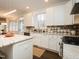 Bright kitchen featuring modern appliances, custom cabinets, and a view to the dining area at 104 Manchester Pl, Chapel Hill, NC 27516