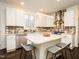 Spacious kitchen featuring an island with seating, stylish fixtures, and stainless steel appliances at 104 Manchester Pl, Chapel Hill, NC 27516
