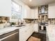Modern kitchen featuring stainless steel appliances, a stylish backsplash, and granite countertops at 104 Manchester Pl, Chapel Hill, NC 27516