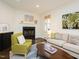 Cozy living room featuring a fireplace, hardwood floors, comfortable seating, and stylish decor creating a welcoming ambiance at 104 Manchester Pl, Chapel Hill, NC 27516