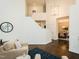 Open living room area featuring staircase access, hardwood floors, and seamless transition into the dining area at 104 Manchester Pl, Chapel Hill, NC 27516
