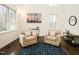 Cozy living room filled with natural light, hardwood floors, comfortable seating, and stylish decor at 104 Manchester Pl, Chapel Hill, NC 27516