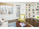 Bright living room featuring custom built-in shelves, a large window, and comfortable furnishings at 104 Manchester Pl, Chapel Hill, NC 27516