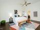 Cozy main bedroom featuring stylish furniture, ceiling fan, decor, and an ensuite bathroom at 104 Manchester Pl, Chapel Hill, NC 27516