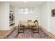 Home office with a large desk, built-in shelving, and a patterned rug over hardwood floors at 104 Manchester Pl, Chapel Hill, NC 27516